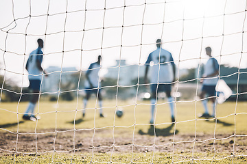 Image showing Goal post, field and football players training for sports energy, workout or game on blurred background. Fitness, focus and power of soccer team or group of people on a pitch in park for challenge