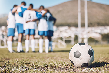 Image showing Ball, sports field and team huddle, game and training for competition, fitness and exercise outdoor. Football, athletic group hug and planning for match, teamwork and wellness on grass, goal and zoom