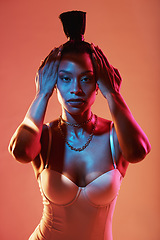 Image showing Portrait, hands and hair with a model black woman in studio on a neon background for beauty. Fashion, art and kaleidoscope with an attractive young female posing indoor for culture or cosmetics