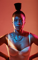 Image showing Portrait, neon and style with a model black woman in studio on a kaleidoscope background for beauty. Art, makeup and fashion with an attractive young female posing indoor for culture or cosmetics