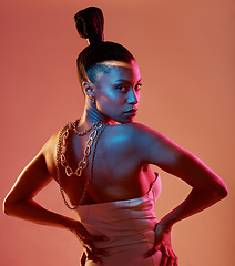 Image showing Portrait, art and neon with a model black woman in studio posing in underwear on an orange background. Aesthetic, beauty and fashion with an attractive young female standing on a kaleidoscope wall