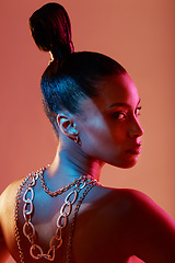 Image showing Glamour, jewelry and portrait of a model in a studio with neon lights for aesthetic and cosmetics. Makeup, art and young woman with cosmetic beauty routine with accesories posing by orange background