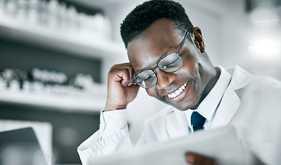 Image showing Doctor, black man and tablet in lab for research, medical knowledge or happy for success, healthcare or career. Scientist, mobile touchscreen tech and focus for pharma innovation, motivation and goal