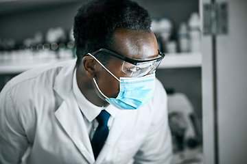 Image showing Covid, mask and scientist working in a lab for research on a pandemic for healthcare and medicine. Black man, technician and science professional or doctor learning cancer or epidemic development