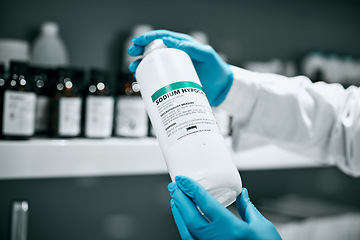 Image showing Science, pharmaceutical chemical and bottle hands from shelf in laboratory for medical research. Healthcare, medicine and innovation in manufacturing of vaccine or prescription drugs with scientist.