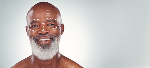 Image showing Skincare, portrait and senior man relax in studio with face cream, sunscreen and product on grey background. Facial, wrinkles and elderly model happy with skin, treatment and luxury cosmetics