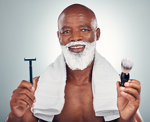 Image showing Black man, beard and razor for shaving, skincare or cosmetic cream for grooming or self care against gray studio background. Portrait of happy African American male with shave kit for clean facial