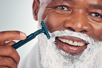 Image showing Black man, face zoom and shaving cream with razor, portrait for beauty and grooming isolated on studio background. Facial hair removal, happy elderly person and hygiene with skincare and wellness