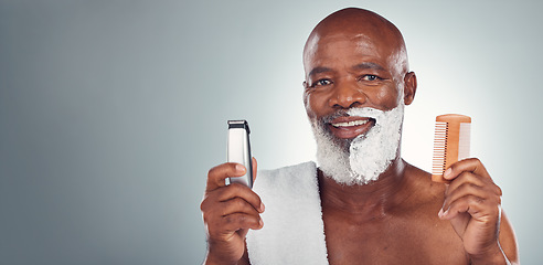 Image showing Black man, beard and shaving with razor, cream or comb in cosmetics for skincare, grooming or self care against gray studio background. Portrait of happy African American male and shave kit on mockup