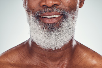 Image showing Smile, beard and face with a senior black man grooming in studio on a gray background for beauty or skincare. Skin, hygiene and cosmetics with a mature male indoor to promote facial hair maintenance