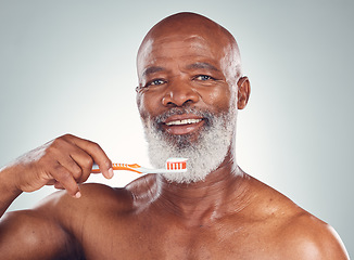 Image showing Dental care portrait, senior man and morning toothbrush for oral hygiene in studio for wellness. Gray background, happy face and elderly person with teeth cleaning product and toothpaste product