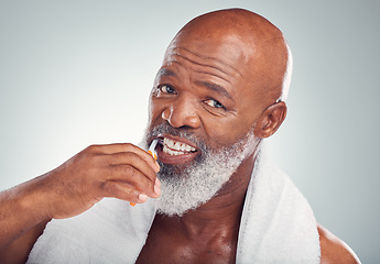 Image showing Black man brushing teeth, portrait and toothbrush, mouth care and fresh breath, hygiene isolated on studio background. Health, wellness and cleaning with dental, senior person and retirement