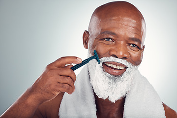 Image showing Black man, face and cream to shave with razor, portrait for beauty and grooming isolated on studio background. Facial hair removal, happy elderly person and hygiene with skincare and wellness
