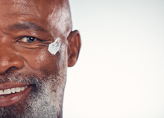 Image showing Closeup, portrait and senior man with face cream in studio for skincare, beauty and grooming on white background. Facial, zoom and elderly model relax for luxury, cosmetic or wrinkle product isolated