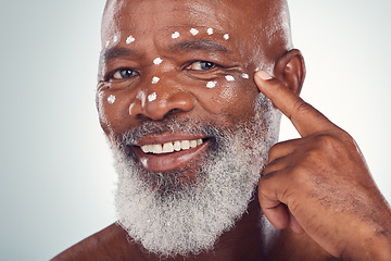 Image showing Face cream, portrait and senior man in studio for skincare, beauty and grooming against grey background. Facial, skin and elderly model relax with luxury, cosmetics and wrinkle product while isolated