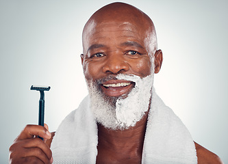 Image showing Black man, face and shaving cream with razor, portrait for beauty and grooming isolated on studio background. Facial hair removal, happy elderly person and hygiene with skincare and wellness