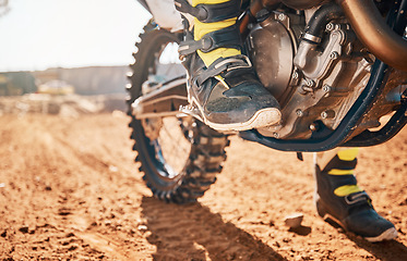 Image showing Dirt road, competition and man feet on motorcycle in desert for exercise, training or rally. Offroad, fitness and male athlete or biker riding on motorbike for action, adventure and extreme sports.