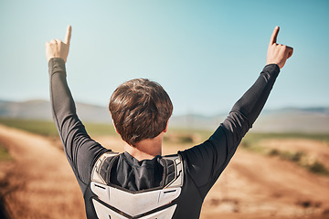 Image showing Winner, hands and back of a sports man outdoor on a dirt track for racing, competition or adrenaline. Success, celebration and winning with a male athlete or biker standing hands raised outside