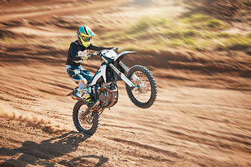 Image showing Motorcycle, dirt track stunt and air jump in desert, sand trail and freedom. Driver, cycling and offroad freedom, sports competition and motorbike performance on adventure course for fast action show