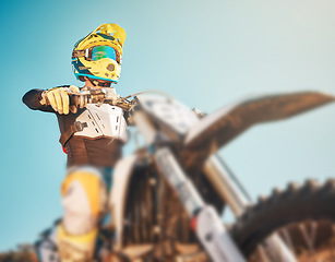 Image showing Motorbike, sports gear and man on blue sky mockup for challenge, race and rally. Driver, bike and ready for motorcross competition, performance and action of fearless adventure, power and start show