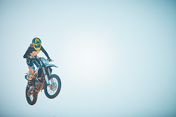 Image showing Bike, motorcycle and jump on blue sky mockup for speed challenge, sports and fearless risk. Driver, air stunt and driving with adrenaline in competition performance, adventure and fast motorbike race