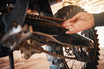 Image showing Hands, mechanic and motorbike chain in repairs working on springs or timing for safety or mechanical parts. Hand of engineer fixing bike, transport or transmission on automobile or gears in workshop