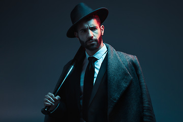 Image showing Fashion, criminal and face of man with bat for vintage, retro and Victorian gangster on dark background. Crime aesthetic, thinking and male model with luxury, designer suit and threatening attitude