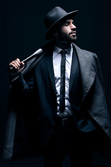 Image showing Criminal, fashion and man with bat for vintage, retro and Victorian gangster on dark background. Crime aesthetic, violence and male model with baseball weapon, threatening attitude and confidence