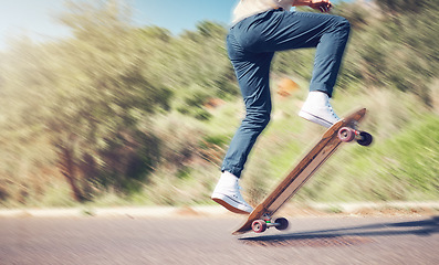 Image showing Sports, skill and man on a skateboard in the road for an outdoor hobby, training or exercise. Gen z, blur motion and male skater or athlete skating in the street for a fitness workout in nature.