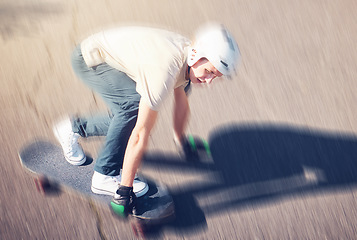 Image showing Skate, motion blur and speed with a sports man skating on a road outdoor from above. Skateboard, soft focus and fast with a young male athlete or skater training outside on an asphalt street