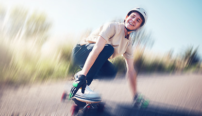 Image showing Skateboard, blurred motion and fast with a sports man skating on an asphalt road outdoor for recreation. Skate, soft focus and speed with a male athlete or skater training outside on the street