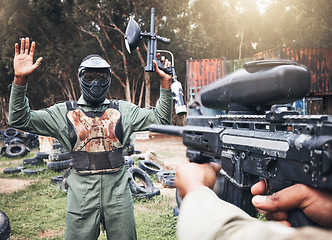 Image showing Paintball, gun and soldier target of military, war and army game training in a forest for exercise. Man surrender, sports and battlefield shooting outdoor in a field for fitness and sport training