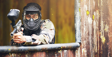 Image showing Paintball, gun and war with a sports man playing a military game for fun or training outdoor. Camouflage, soldier and target with a male athlete shooting a weapon outside during an army exercise