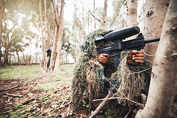 Image showing Forrest men, aim paintball gun and trees for outdoor war game, strategy or focus in natural camouflage. Sniper, army clothes and helmet for safety with eyes on target for success in military games