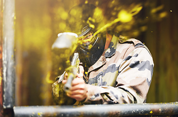 Image showing Paintball, soldier and camouflage with a sports man playing a military game for fun or training outdoor. War, gun and target with a male athlete shooting a weapon outside during an army exercise