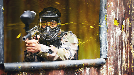 Image showing Paintball, gun and soldier with a sports man playing a military game for fun or training outdoor. War, camouflage and target with a male athlete shooting a weapon outside during an army exercise