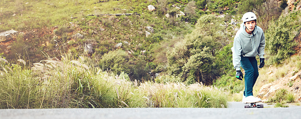 Image showing Skateboard, nature and mockup with a sports man on an asphalt street skating through the mountains. Skater, green and mock up with a male athlete skateboarding on a road alone in the wilderness