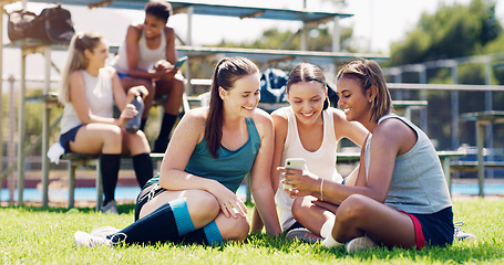 Image showing Sports, women and group outdoor, smartphone and connection with girls on field, chatting and relax. Fitness, female athletes smile and young ladies with cellphone, summer and on break after training