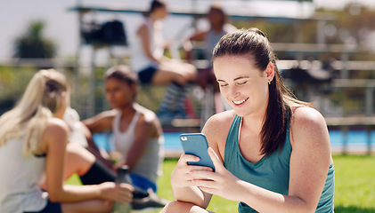 Image showing Woman, sports field and texting with phone, social media and communication for online dating, happy or smile. Gen z girl, cellphone and outdoor happiness for chat app, web or laugh at meme on website