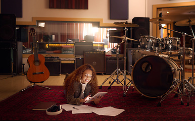 Image showing Music studio, tablet and black woman on floor with paper online for notes, lyrics and inspiration on internet. Musical instruments, creative industry and girl musician with digital tech for research