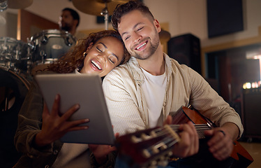 Image showing Guitar, music and couple with digital tablet for online lyrics or strumming notes in recording studio. Happy, smile and young man and woman with mobile device and acoustic string instrument at night.