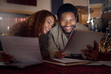 Image showing Streaming music, musician and couple with a tablet for an app, funny video and performance idea in dark. Laughing, creative and artist, song writer or black man and woman with tech for inspiration