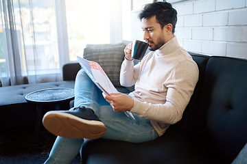 Image showing Relax and reading newspaper by man with coffee or drinking tea in a home, house or apartment on weekend. Mexican, news and young person enjoying free time with an article, story or paper