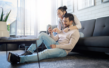 Image showing Interracial, couple and people with phone on social media laughing at meme or funny internet content. Man, woman and lovers relax in home, house or apartment browsing the web, website or app