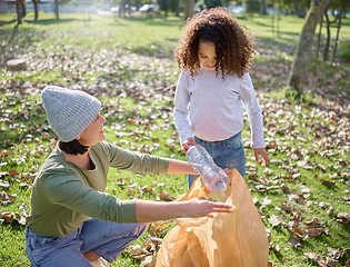 Image showing Trash, volunteer woman and child cleaning garbage, pollution or waste product for community environment support. Plastic bag container, NGO charity and eco friendly kid help with nature park clean up