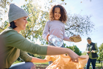 Image showing Recycle plastic, bottle and people with child in park for community service, volunteering and cleaning education. Happy woman with kid in nature forest for recycling, pollution and earth day support