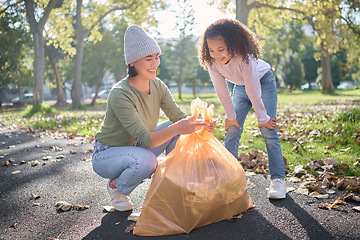 Image showing Trash, volunteer woman and kid cleaning garbage, pollution or waste product for environment community service. Plastic bag container, NGO charity and eco friendly child help with nature park clean up