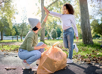 Image showing High five, volunteer woman and kid cleaning garbage pollution, waste product or community environment support. Teamwork celebration, NGO charity and eco friendly child done with nature park clean up