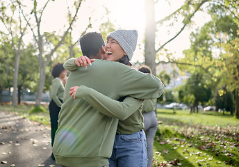 Image showing Hug, friends and happy volunteer people outdoor at nature park with care for earth. Woman and man team together for community service in green ngo tshirt for recycling, cleaning and clean enviroment