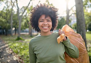 Image showing Trash, volunteer portrait and black woman cleaning garbage pollution, waste product or environment support. Plastic bag container, NGO charity and eco friendly person help with nature park clean up